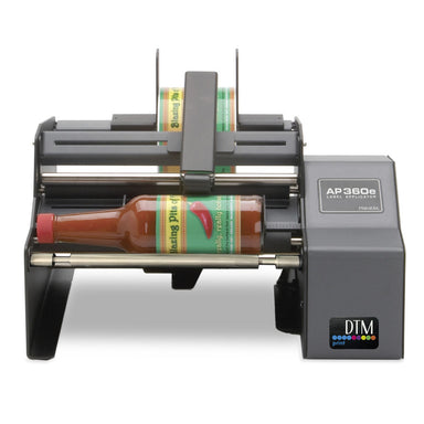 DTM AP360e round bottle label applicator with a hot sauce bottle, front view