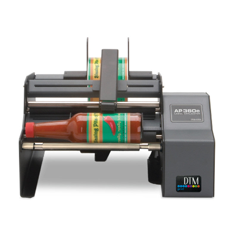 DTM AP360e bottle label applicator holding a sauce bottle, front view