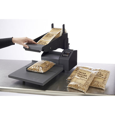 DTM AP550e flat surface label applicator with a pecan container